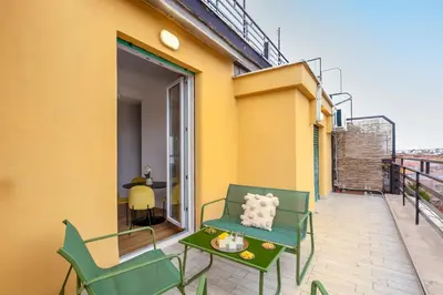 a balcony with a green chair and a table at Casa Vespi by Hili in Rome