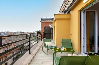 a balcony with chairs and a table on a building at Casa Vespi by Hili in Rome