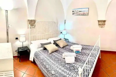 a bedroom with a large bed in a room at Vacanze Romane al Portico d'Ottavia in Rome