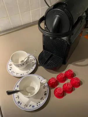 a counter with three plates and a tea pot and cupcakes at Vacanze Romane al Portico d'Ottavia in Rome
