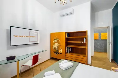 a bedroom with a desk and a glass table at The Space Rooms in Rome