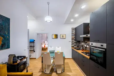 a kitchen with a table and chairs in a room at The Space Rooms in Rome