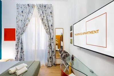 a bedroom with a flat screen tv on a wall at The Space Rooms in Rome