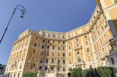 a large yellow building with a blue sky in the background at Home and More St. Angelo APT 5 in Rome