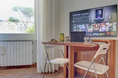a kitchen with a table and two white chairs at Home and More St. Angelo APT 5 in Rome