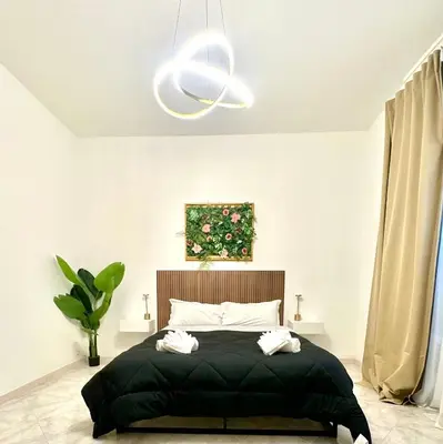 a bedroom with a bed with two towels on it at Golden Luxury Home - San Giovanni - 3 min to Colosseum in Rome