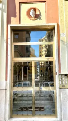 a window of a building with a view of a city at Golden Luxury Home - San Giovanni - 3 min to Colosseum in Rome