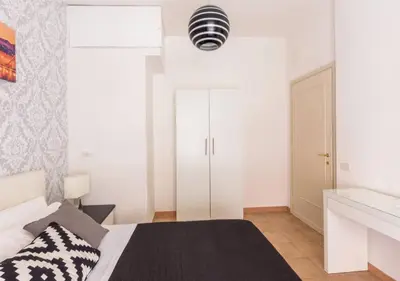 a white bedroom with a bed and a white closet at Navona Home in Rome