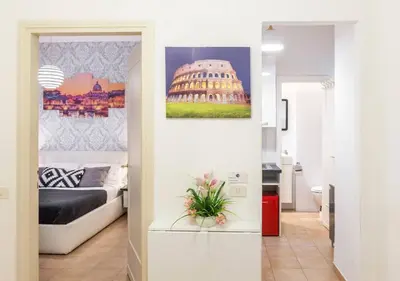 a room with a bed and a picture of the coliseum at Navona Home in Rome