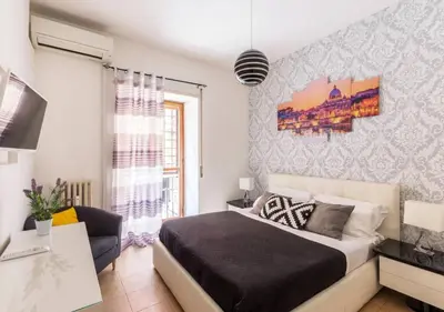 a bedroom with a bed and a desk and a window at Navona Home in Rome