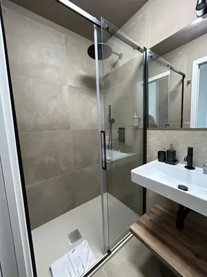 a bathroom with a shower and a sink at Sopi Vatican Suite Apartment in Rome