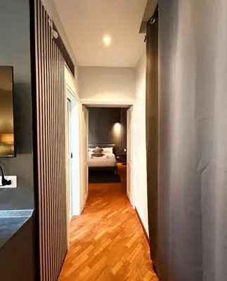 a hallway leading to a bedroom with a bed at Sopi Vatican Suite Apartment in Rome