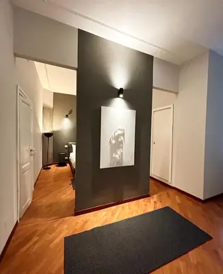 a living room with a black rug on a wall at Sopi Vatican Suite Apartment in Rome