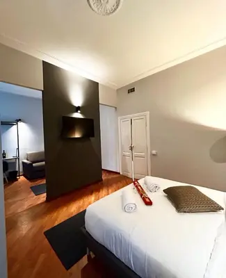 a bedroom with a bed with a light on the wall at Sopi Vatican Suite Apartment in Rome