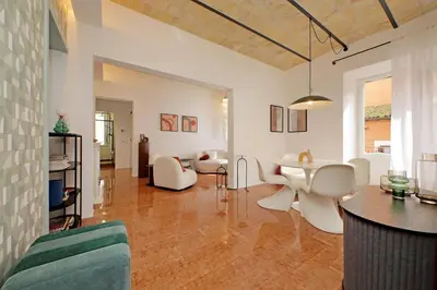 a living room with white chairs and a table at YCH-Lussuoso appartamento al Colosseo in Rome