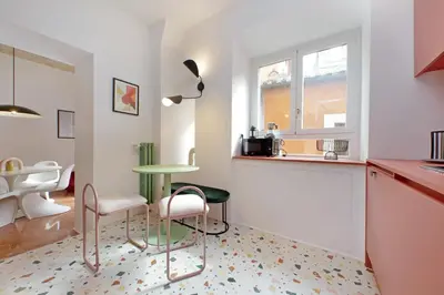 a kitchen with a table and some chairs and a counter at YCH-Lussuoso appartamento al Colosseo in Rome