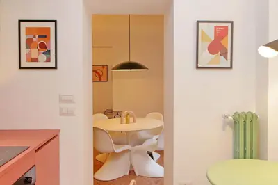 a kitchen with a table and chairs in a room at YCH-Lussuoso appartamento al Colosseo in Rome