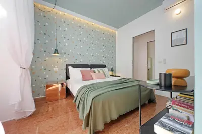 a bedroom with a bed and a table at YCH-Lussuoso appartamento al Colosseo in Rome
