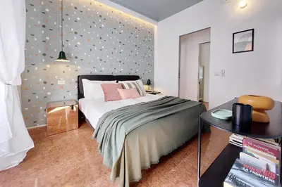 a bedroom with a bed and a table in a room at YCH-Lussuoso appartamento al Colosseo in Rome