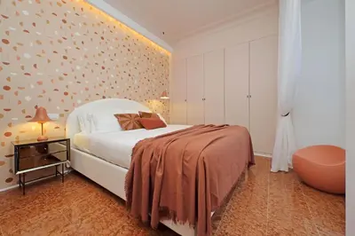 a bedroom with a bed and a wall with polka dots at YCH-Lussuoso appartamento al Colosseo in Rome