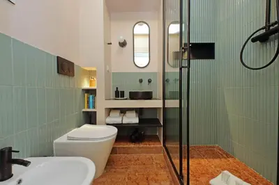 a bathroom with a toilet and a sink and a shower at YCH-Lussuoso appartamento al Colosseo in Rome