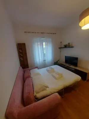 a bedroom with a large bed and a couch at VATICAN PITTORE HOUSE in Rome