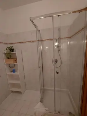 a shower with a glass door in a bathroom at VATICAN PITTORE HOUSE in Rome