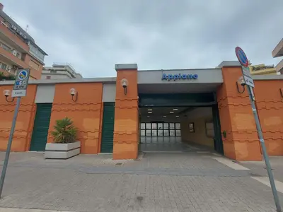 a building with a parking sign in front of it at VATICAN PITTORE HOUSE in Rome