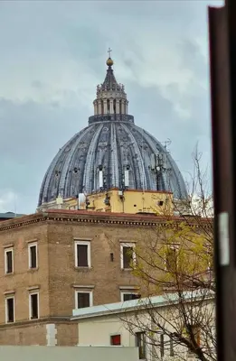 a building with a dome on top of a building at Suite Noir St Peter View in Rome