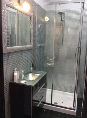 a bathroom with a sink and a shower at Suite Noir St Peter View in Rome