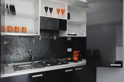 a kitchen with a sink and a stove top oven at Suite Noir St Peter View in Rome