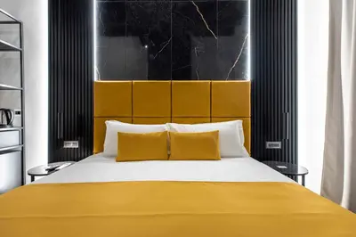 a bedroom with a large bed with two yellow pillows at Home at Rome Luxury Navona Guest House 2 in Rome