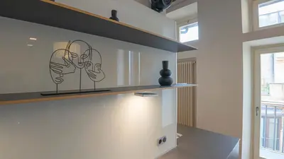 a kitchen with a shelf with two faces on it at EasyTopStay - Piazza Venezia City View Charming Apt in Rome