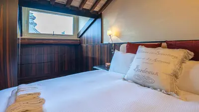 a bedroom with a large bed with a window at EasyTopStay - Piazza Venezia City View Charming Apt in Rome