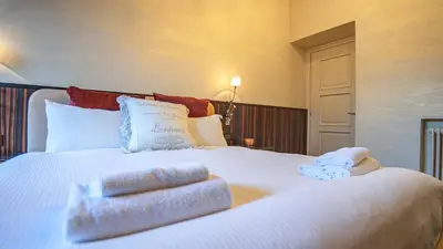 a bedroom with a large white bed with towels on it at EasyTopStay - Piazza Venezia City View Charming Apt in Rome