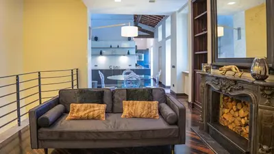 a living room with a couch and a fireplace at EasyTopStay - Piazza Venezia City View Charming Apt in Rome