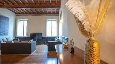 a vase with feathers on a table in a living room at EasyTopStay - Piazza Venezia City View Charming Apt in Rome