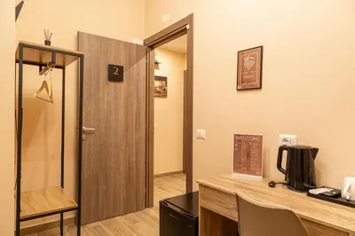 a room with a desk and a door with a sign at Diamond Vatican Apartment in Rome