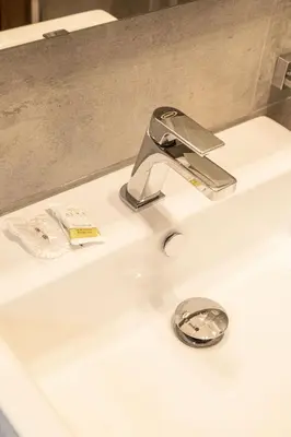 a bathroom sink with a chrome faucet on it at Diamond Vatican Apartment in Rome