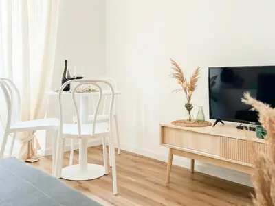 a living room with a tv and a table and chairs at Grazioso appartamento al Pigneto in Rome