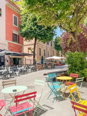 a group of colorful tables and chairs on a city street at Grazioso appartamento al Pigneto in Rome