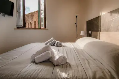 a bedroom with a bed with towels on it at VivimiHome - Holiday Life Rome in Rome
