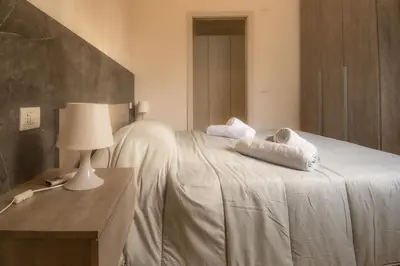 a bedroom with a bed with towels on it at VivimiHome - Holiday Life Rome in Rome