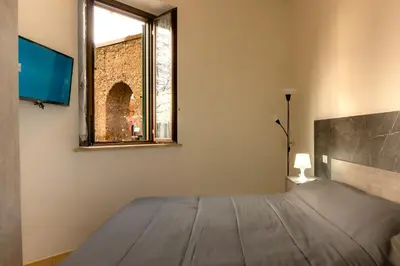 a bedroom with a bed and a window at VivimiHome - Holiday Life Rome in Rome