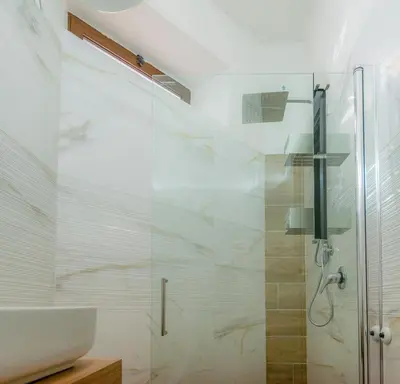 a bathroom with a glass shower and a sink at VivimiHome - Holiday Life Rome in Rome