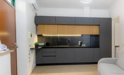 a kitchen with black cabinets and a sink at VivimiHome - Holiday Life Rome in Rome