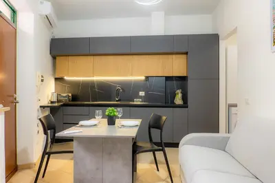 a kitchen and dining room with a table and a couch at VivimiHome - Holiday Life Rome in Rome