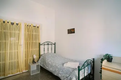 a bedroom with a bed and a window at Villa Fiorelli rooms in Rome