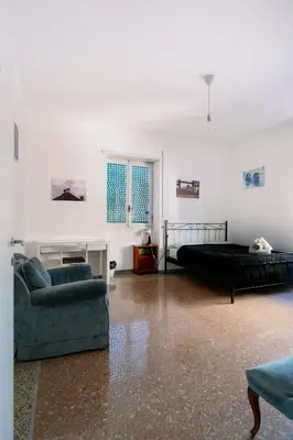 a living room with a couch and a bed at Villa Fiorelli rooms in Rome