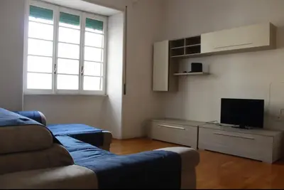 a living room with a blue couch and a tv at Appartamento 5 stelle in Piazza Asti - Re di Roma - in Rome